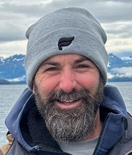 image of Dion with water and mountains in the background